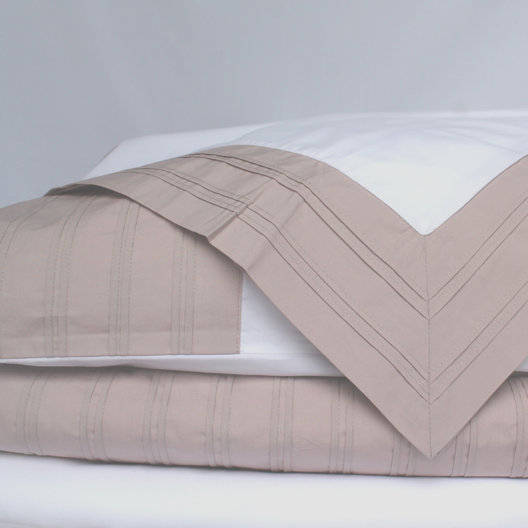 white organic bedding with dusky pink pleat detail